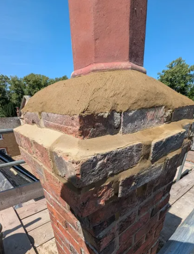 Chimney repair with fresh pointing and flaunching on a brick stack
