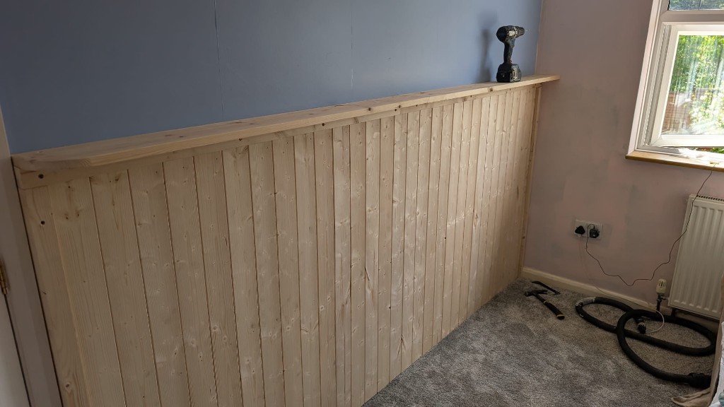 Finished custom wooden wall panelling with matching top ledge
