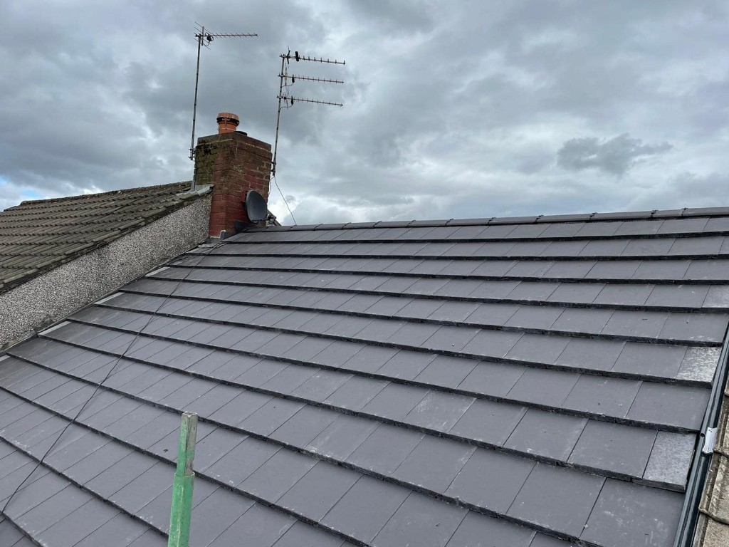 New dark grey flat tile roof installation